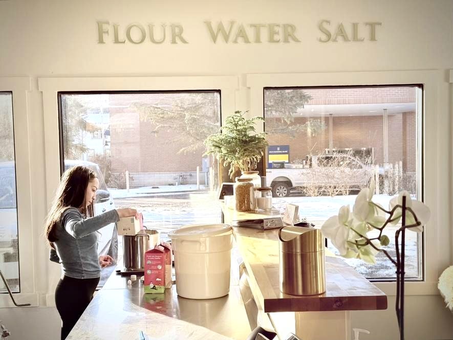 Working at the counter beneath the Flour Water Salt lettering